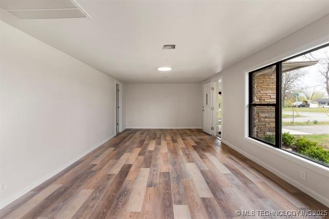 unfurnished room with hardwood / wood-style floors