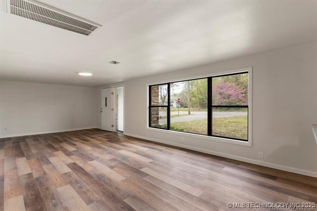 unfurnished room featuring wood-type flooring