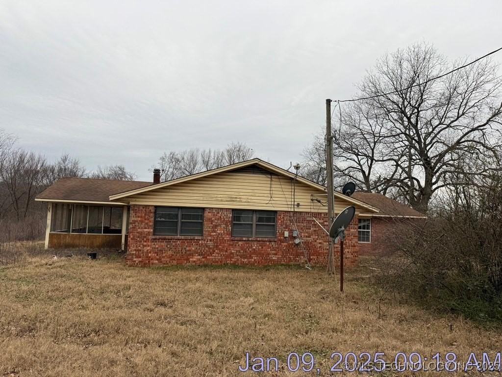 view of side of property with a sunroom