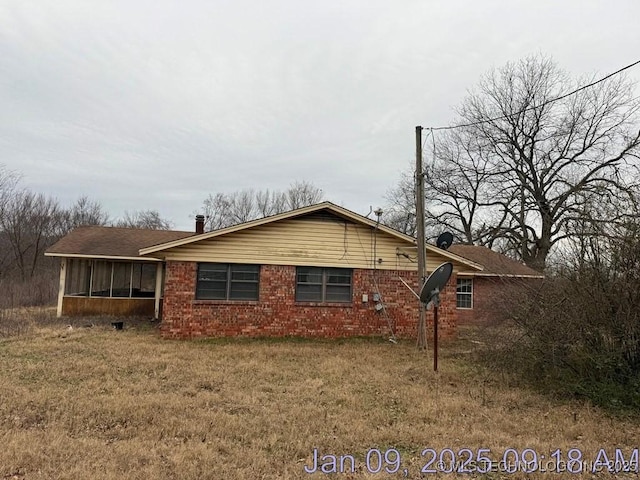 view of side of property with a sunroom