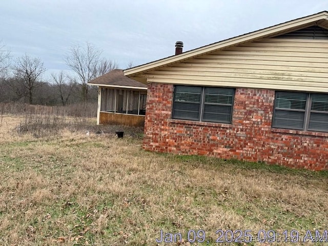 view of home's exterior featuring a sunroom