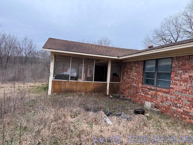 view of side of property with a sunroom