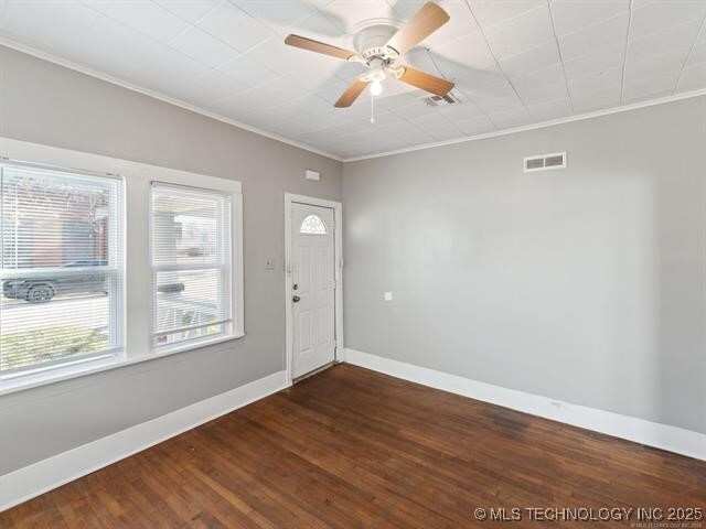 entryway featuring crown molding, dark hardwood / wood-style flooring, and ceiling fan