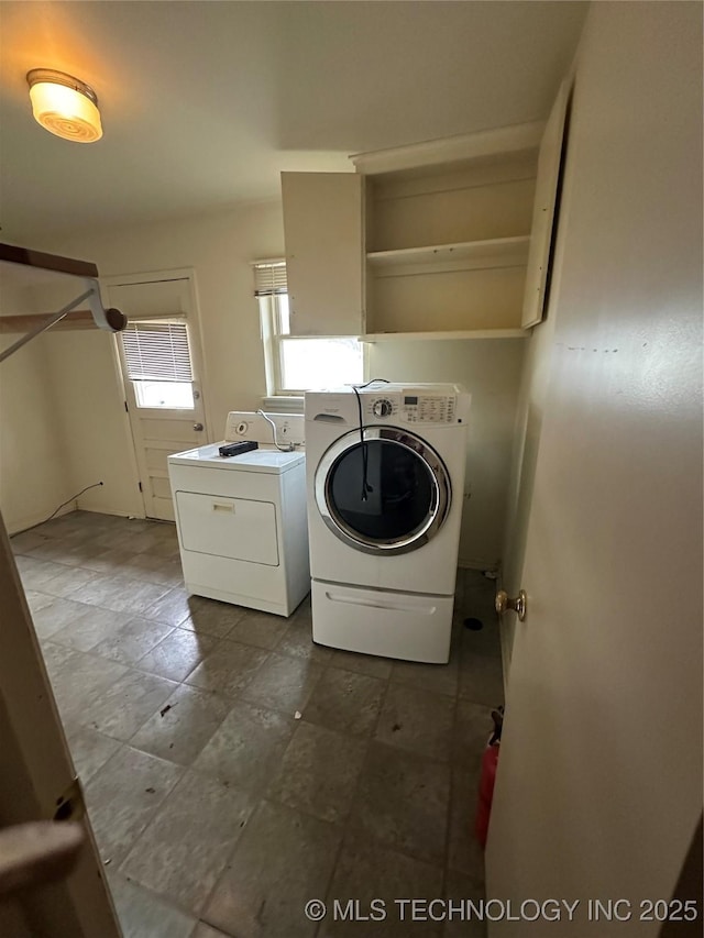 washroom with washing machine and clothes dryer