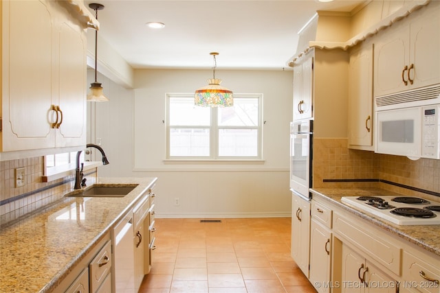 6740 E 51st Pl, Tulsa, OK 74145 - kitchen featuring a sink, white appliances, tasteful backsplash, and pendant lighting