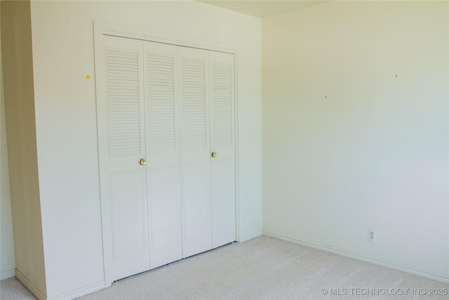 6740 E 51st Pl, Tulsa, OK 74145 - unfurnished bedroom featuring light colored carpet, a closet, and baseboards