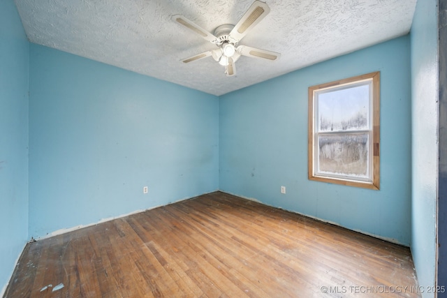 empty room featuring hardwood / wood-style floors, ceiling fan, and a textured ceiling