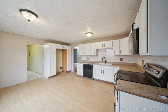 kitchen with backsplash, sink, electric range, light hardwood / wood-style flooring, and white cabinetry