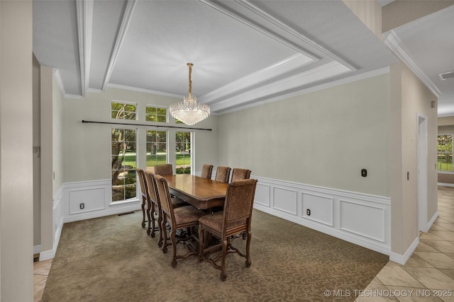 dining room featuring light tile patterned floors, visible vents, a wealth of natural light, and ornamental molding