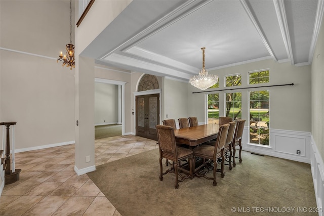 dining room featuring crown molding, french doors, light tile patterned floors, and an inviting chandelier