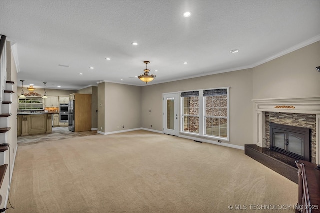 unfurnished living room with a fireplace, light colored carpet, a textured ceiling, and ornamental molding