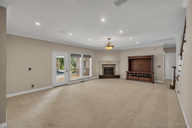 unfurnished living room featuring crown molding, recessed lighting, light carpet, a stone fireplace, and baseboards