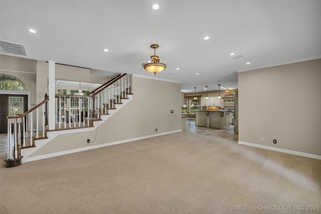 unfurnished living room with light carpet, plenty of natural light, and ornamental molding