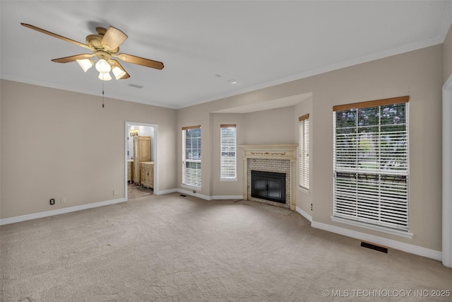 unfurnished living room featuring a wealth of natural light, light carpet, a fireplace, and ceiling fan