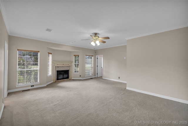 unfurnished living room featuring baseboards, a healthy amount of sunlight, a brick fireplace, and light colored carpet