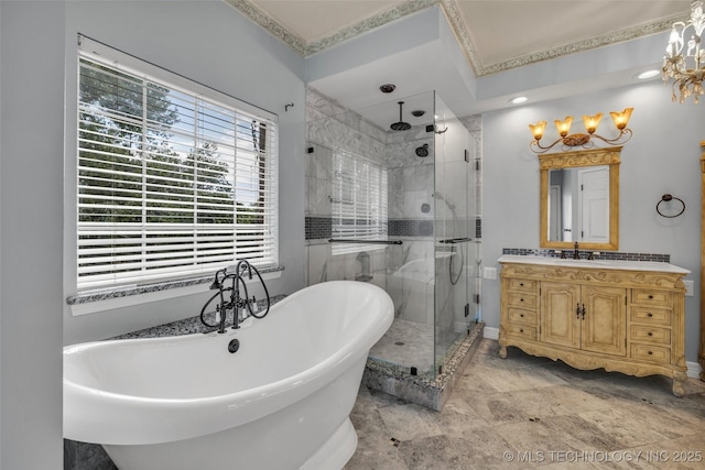 full bathroom with a shower stall, a freestanding bath, and vanity