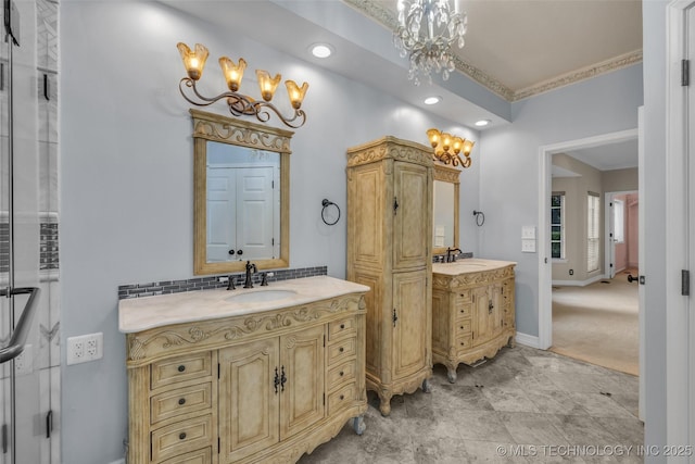 bathroom featuring backsplash, vanity, and a notable chandelier