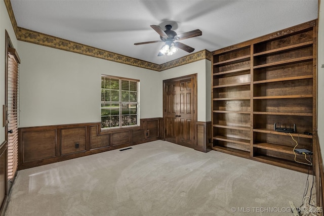 unfurnished bedroom featuring light colored carpet and ceiling fan