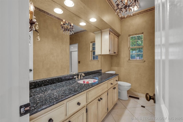 bathroom with visible vents, vanity, a chandelier, baseboards, and tile patterned floors