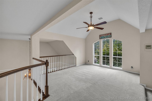 unfurnished living room with ceiling fan with notable chandelier, lofted ceiling, and light carpet