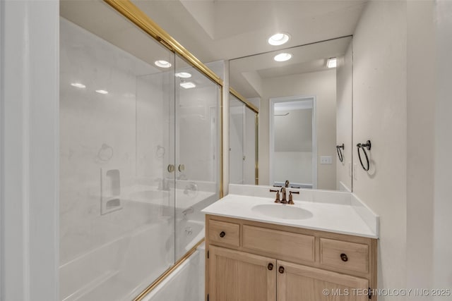 bathroom with shower / bath combination with glass door and vanity