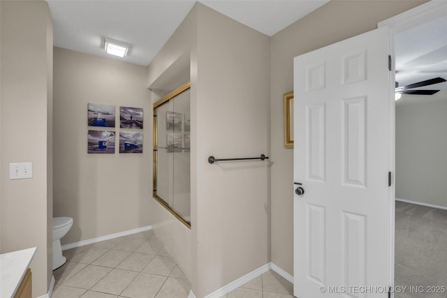 full bathroom with enclosed tub / shower combo, ceiling fan, toilet, vanity, and tile patterned floors