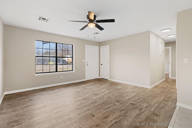 spare room featuring ceiling fan and light wood-type flooring