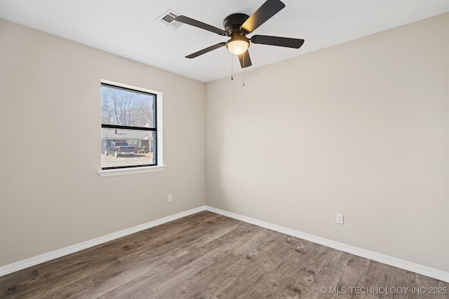 spare room with ceiling fan and wood-type flooring