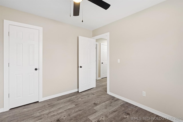 unfurnished bedroom featuring ceiling fan and light hardwood / wood-style flooring