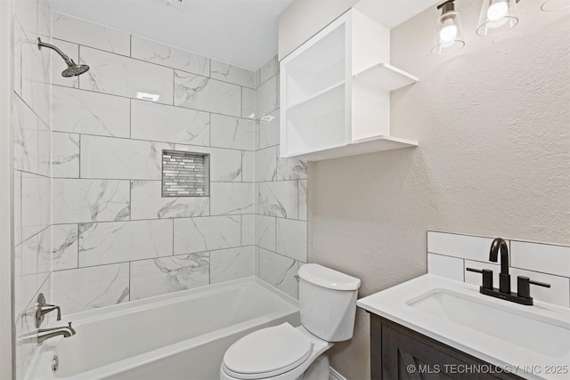 full bathroom with vanity, toilet, and tiled shower / bath