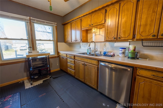 kitchen featuring a textured ceiling, dishwasher, ornamental molding, and sink