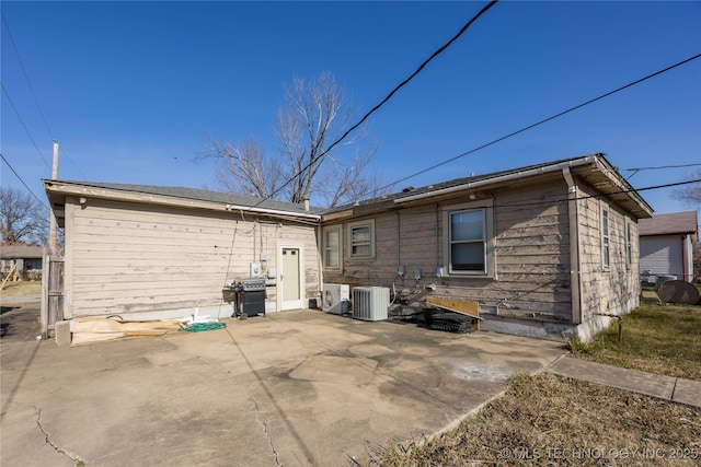 rear view of property with a patio and central air condition unit