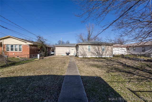 back of property featuring a yard