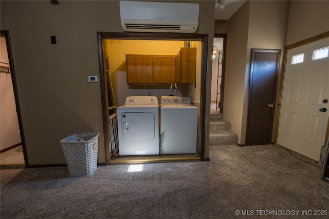 laundry area with a wall unit AC, separate washer and dryer, carpet flooring, and cabinets