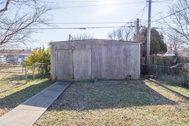 view of outbuilding featuring a lawn