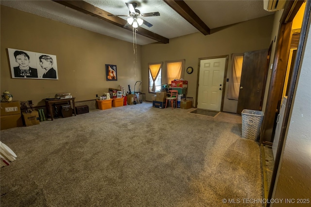 misc room featuring beam ceiling, carpet floors, a textured ceiling, and ceiling fan