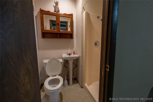 bathroom with a shower, sink, and toilet