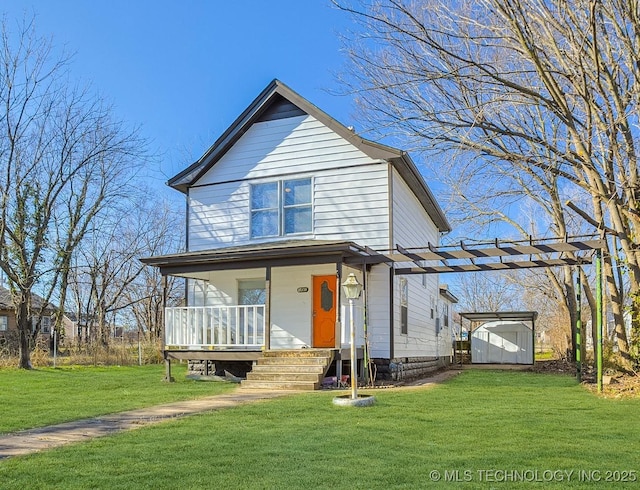 view of front of home featuring a front yard, a porch, and a storage shed