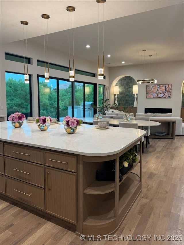 5835 E 139th St S, Bixby, OK 74008 - kitchen with open shelves, open floor plan, light wood-type flooring, recessed lighting, and decorative light fixtures
