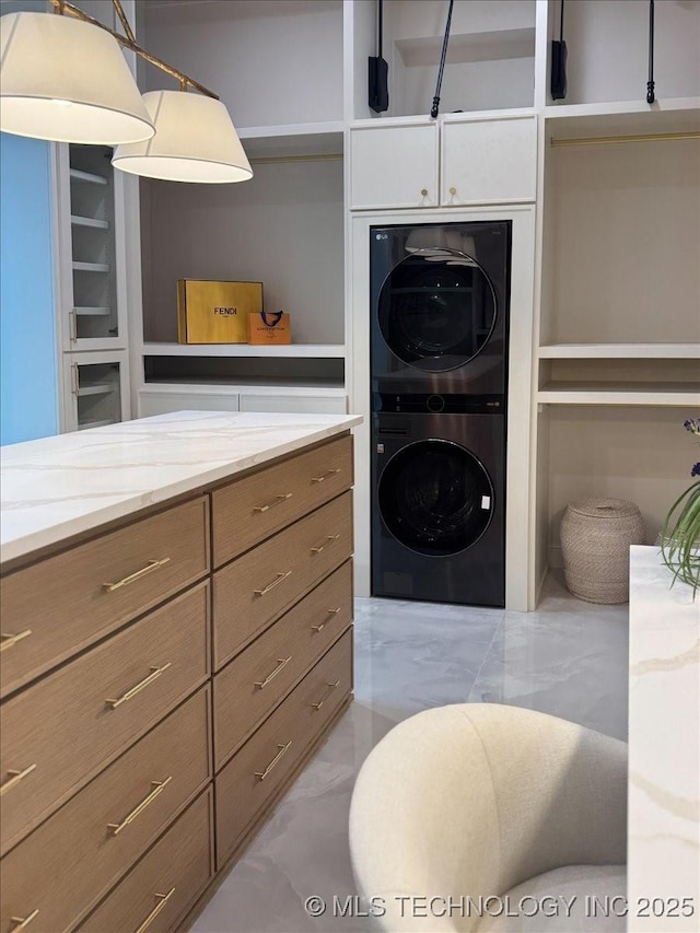 5835 E 139th St S, Bixby, OK 74008 - washroom featuring stacked washer / drying machine and light marble finish flooring