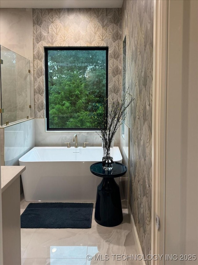 5835 E 139th St S, Bixby, OK 74008 - full bath with a soaking tub, marble finish floors, wallpapered walls, and tile walls