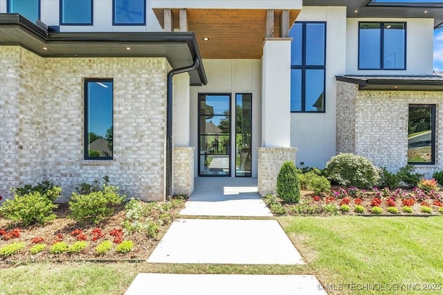 5835 E 139th St S, Bixby, OK 74008 - view of exterior entry with stucco siding and a yard
