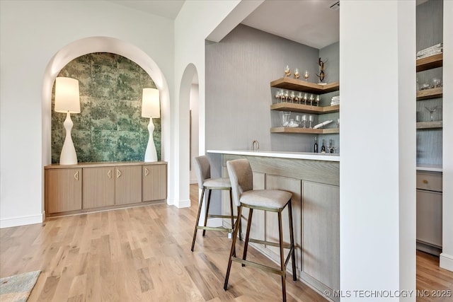5835 E 139th St S, Bixby, OK 74008 - indoor wet bar with arched walkways and light wood-style floors