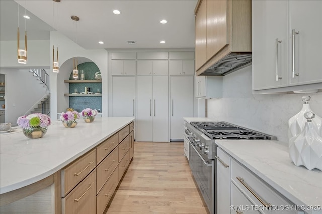 5835 E 139th St S, Bixby, OK 74008 - kitchen with stainless steel range, premium range hood, light wood-type flooring, recessed lighting, and light stone counters