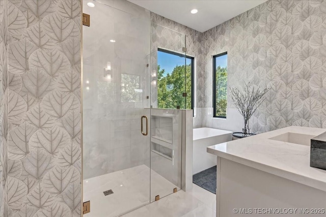 5835 E 139th St S, Bixby, OK 74008 - bathroom with a soaking tub, vanity, a shower stall, recessed lighting, and tile walls