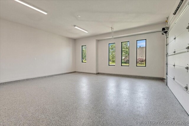 5835 E 139th St S, Bixby, OK 74008 - garage featuring baseboards