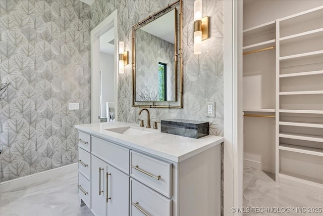 5835 E 139th St S, Bixby, OK 74008 - bathroom with wallpapered walls, vanity, marble finish floors, and a walk in closet