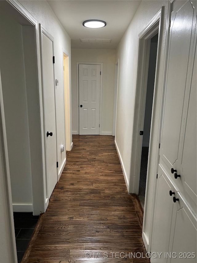 corridor featuring dark wood-type flooring