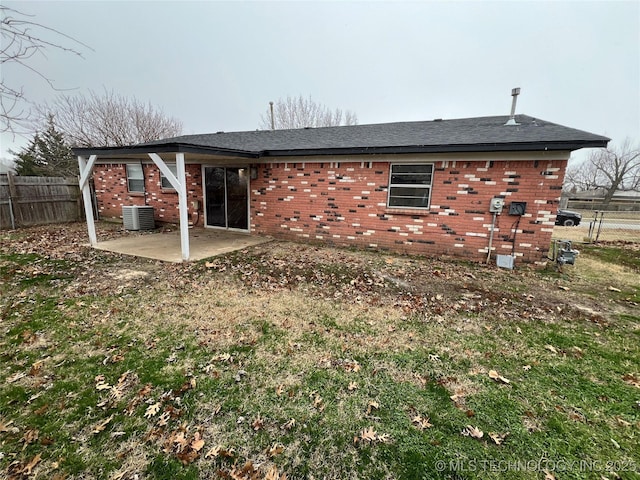 rear view of property featuring cooling unit and a patio