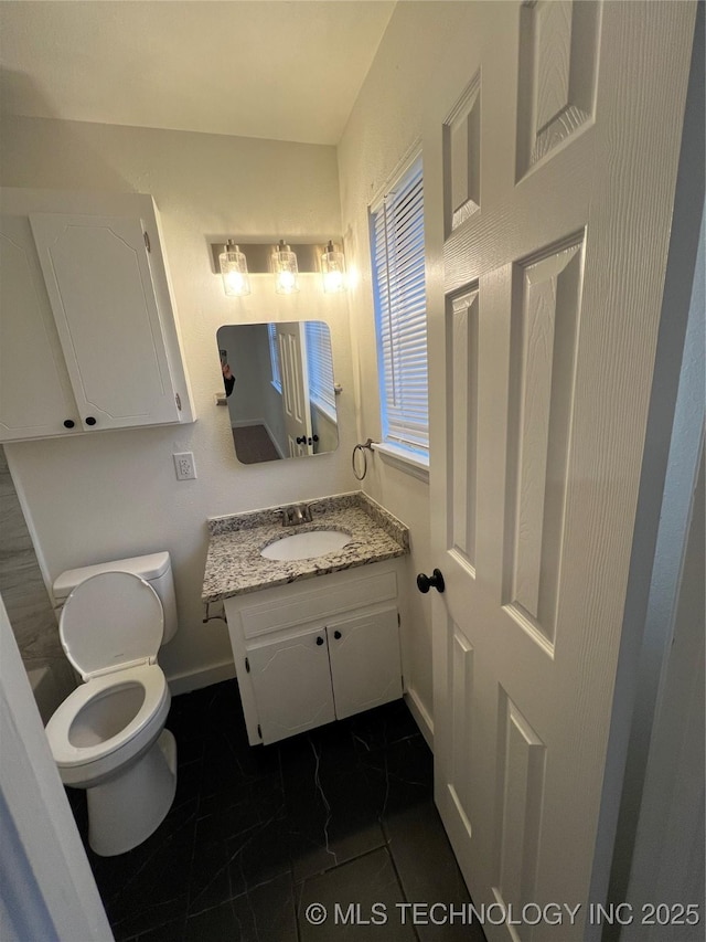 bathroom with tile patterned floors, vanity, and toilet